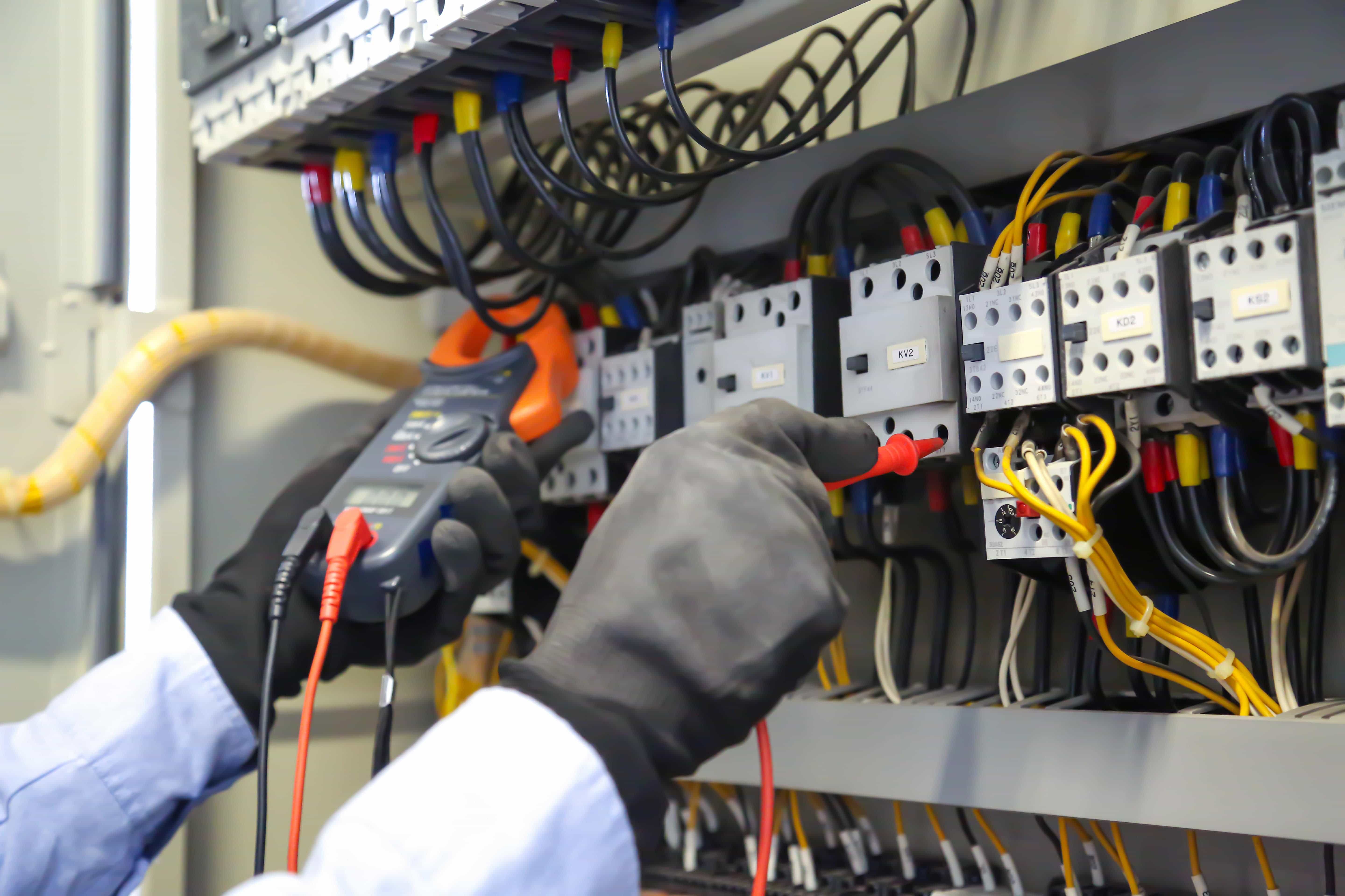 close up-hand-using-measuring-tool-checking-electricity-circuit-breaker-min